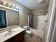 Cozy bathroom with a shower-tub combo, single sink vanity, and ceramic tile flooring at 1946 Central Park W Blvd, Greenwood, IN 46143