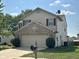 Two-story home boasts a brick-accented garage, tidy landscaping, and a well-manicured lawn at 1946 Central Park W Blvd, Greenwood, IN 46143