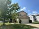 Traditional two-story home features an attached two car garage and front yard landscaping at 1946 Central Park W Blvd, Greenwood, IN 46143