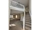 Open-concept foyer with a staircase, carpeted floor, and views into living areas at 1946 Central Park W Blvd, Greenwood, IN 46143