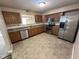 Spacious kitchen with stainless steel appliances, wooden cabinets, and tile floors at 1946 Central Park W Blvd, Greenwood, IN 46143