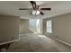 Open living room with carpet, view of stairs, and large windows for natural light at 1946 Central Park W Blvd, Greenwood, IN 46143