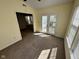 Bright room with neutral carpet and double glass doors that provide outdoor views at 1946 Central Park W Blvd, Greenwood, IN 46143