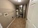 Functional utility room with tile flooring, shelving, and essential appliances at 1946 Central Park W Blvd, Greenwood, IN 46143