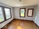 Cozy bedroom with hardwood floors and natural light from two windows at 234 Ringwood Way, Anderson, IN 46013