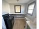 Kitchen featuring a black stove and open shelving for storage solutions at 234 Ringwood Way, Anderson, IN 46013