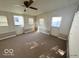 Living room area with ceiling fan, multiple windows and access to exterior at 234 Ringwood Way, Anderson, IN 46013