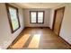 Cozy room with hardwood floors, natural light from windows, and traditional trim at 234 Ringwood Way, Anderson, IN 46013