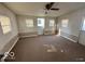 Living room area with ceiling fan, multiple windows and access to exterior at 234 Ringwood Way, Anderson, IN 46013