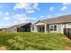 A well-maintained backyard view showcasing covered patios, large windows, and a black metal fence at 16920 Cattle Hollow Ln, Noblesville, IN 46060