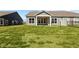 Lush backyard featuring a covered patio and expansive windows, great for enjoying the outdoor space at 16920 Cattle Hollow Ln, Noblesville, IN 46060