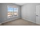 Bedroom with a window overlooking the outside, neutral carpet, and light gray walls at 16920 Cattle Hollow Ln, Noblesville, IN 46060