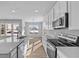 Contemporary kitchen with stainless steel appliances, quartz countertops, and a view of the backyard at 16920 Cattle Hollow Ln, Noblesville, IN 46060