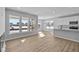 Bright living room with hardwood floors, large windows, and modern kitchen with stainless steel appliances at 16920 Cattle Hollow Ln, Noblesville, IN 46060