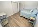 Well-lit bedroom featuring light-colored floors and a comfortable bed with closet doors, creating a relaxing space at 728 E Beecher St, Indianapolis, IN 46203