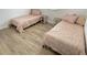 Cozy bedroom with two twin beds, matching pink bedding and side tables, creating a comfortable space at 728 E Beecher St, Indianapolis, IN 46203