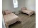 Charming bedroom with two twin beds, matching pink bedding and side tables, creating a comfortable space at 728 E Beecher St, Indianapolis, IN 46203