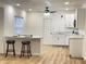 Modern kitchen with sleek white cabinets, granite countertops, ceiling fan, and an open floor plan at 728 E Beecher St, Indianapolis, IN 46203
