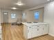 Open-concept kitchen featuring a marble island with white cabinetry, seamless flow into the living area at 728 E Beecher St, Indianapolis, IN 46203