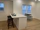 Stylish kitchen island featuring marble countertops, seating for three, and bright natural light at 728 E Beecher St, Indianapolis, IN 46203