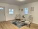 Inviting living room featuring stylish seating, a decorative rug, and ample natural light from the windows at 728 E Beecher St, Indianapolis, IN 46203