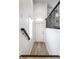 Bright hallway with wood floors, white walls, black handrail, and a window at 729 Greenford N Trl, Carmel, IN 46032