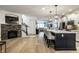 Spacious modern kitchen with a stone fireplace and large island with seating, and stainless appliances at 729 Greenford N Trl, Carmel, IN 46032