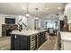 Modern kitchen with a large center island, stainless steel appliances, and a built-in wine fridge at 729 Greenford N Trl, Carmel, IN 46032