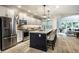 Modern open kitchen with stainless steel appliances and a large center island with seating at 729 Greenford N Trl, Carmel, IN 46032
