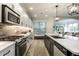 Bright kitchen with stainless steel appliances, subway tile backsplash, and a large center island at 729 Greenford N Trl, Carmel, IN 46032