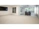 Spacious living room featuring a ceiling fan, access to a patio, and large windows at 729 Greenford N Trl, Carmel, IN 46032