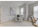 Bright living room with neutral tones, featuring a comfortable chair, and plenty of natural light from the windows at 729 Greenford N Trl, Carmel, IN 46032