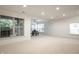 Spacious living room featuring a ceiling fan, access to a patio, and large windows at 729 Greenford N Trl, Carmel, IN 46032