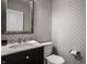 Stylish powder room featuring elegant patterned wallpaper, marble countertop, and modern fixtures at 729 Greenford N Trl, Carmel, IN 46032