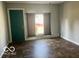 Living room with green door and tile floor at 304 Andover Rd, Anderson, IN 46013
