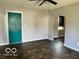 Living room with teal door and tile floor at 304 Andover Rd, Anderson, IN 46013