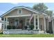 Inviting single story home with a covered front porch, plants, and an American flag at 217 Ringwood Way, Anderson, IN 46013