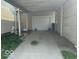 A simple one car detached garage with a white door and concrete driveway at 217 Ringwood Way, Anderson, IN 46013