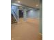 Spacious finished basement with light blue walls and neutral carpet at 10870 Picket Fence Pl, Fishers, IN 46037
