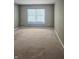 Simple bedroom with neutral walls, carpet, and a large window at 10870 Picket Fence Pl, Fishers, IN 46037