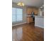 Bright dining room with hardwood floors and a view into the kitchen at 10870 Picket Fence Pl, Fishers, IN 46037