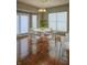 Elegant dining area with hardwood floors, a round table, and modern chairs at 10870 Picket Fence Pl, Fishers, IN 46037