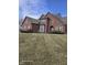 Traditional brick home featuring well-maintained lawn, trimmed shrubs and architectural details at 10870 Picket Fence Pl, Fishers, IN 46037