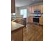 Spacious kitchen featuring wood cabinets, stainless steel appliances, and hardwood floors at 10870 Picket Fence Pl, Fishers, IN 46037
