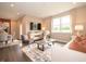 Bright living room features hardwood floors, comfy seating, large windows, and a modern media console at 231 Lar Lan Dr, Danville, IN 46122