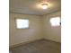 Bedroom with neutral paint, carpeted floors, and two windows offering natural light at 431 Vestal Rd, Plainfield, IN 46168