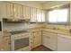 Charming kitchen with white cabinetry, laminate countertops, and bright window light at 431 Vestal Rd, Plainfield, IN 46168