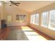 Bright sunroom with hardwood floors, ceiling fan, and many windows offering backyard views at 431 Vestal Rd, Plainfield, IN 46168