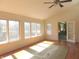 Sunroom with wood flooring, a ceiling fan and an abundance of natural light from the surrounding windows at 431 Vestal Rd, Plainfield, IN 46168