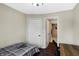 Small bedroom with view of the bathroom and dark floors at 1938 E 11Th St, Indianapolis, IN 46201